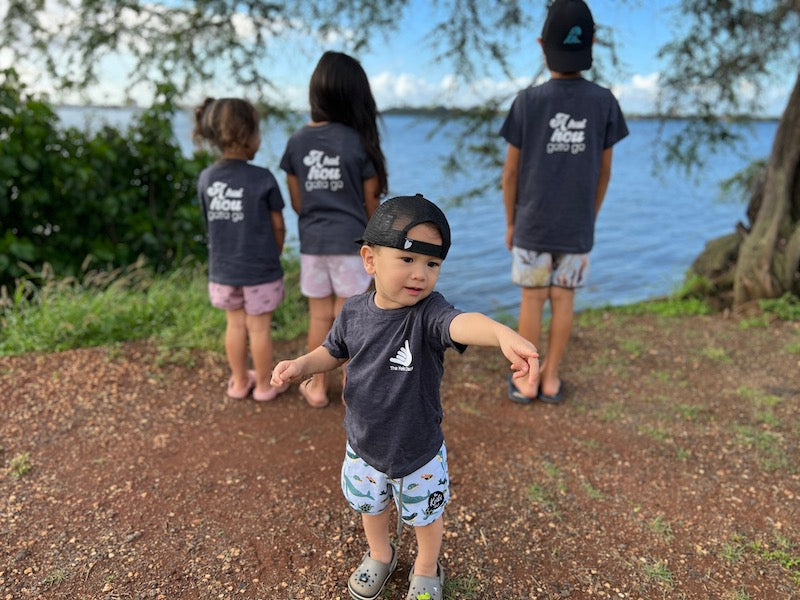 a hui hou group shot, kids facing the water and baby facing the camera
