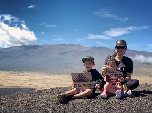 mom and two kids in front of mauna kea