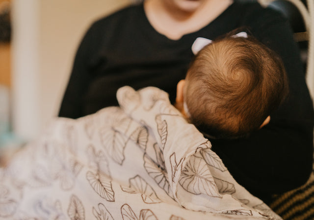 breastfeeding baby with the keiki dept kalo kapa moe swaddle