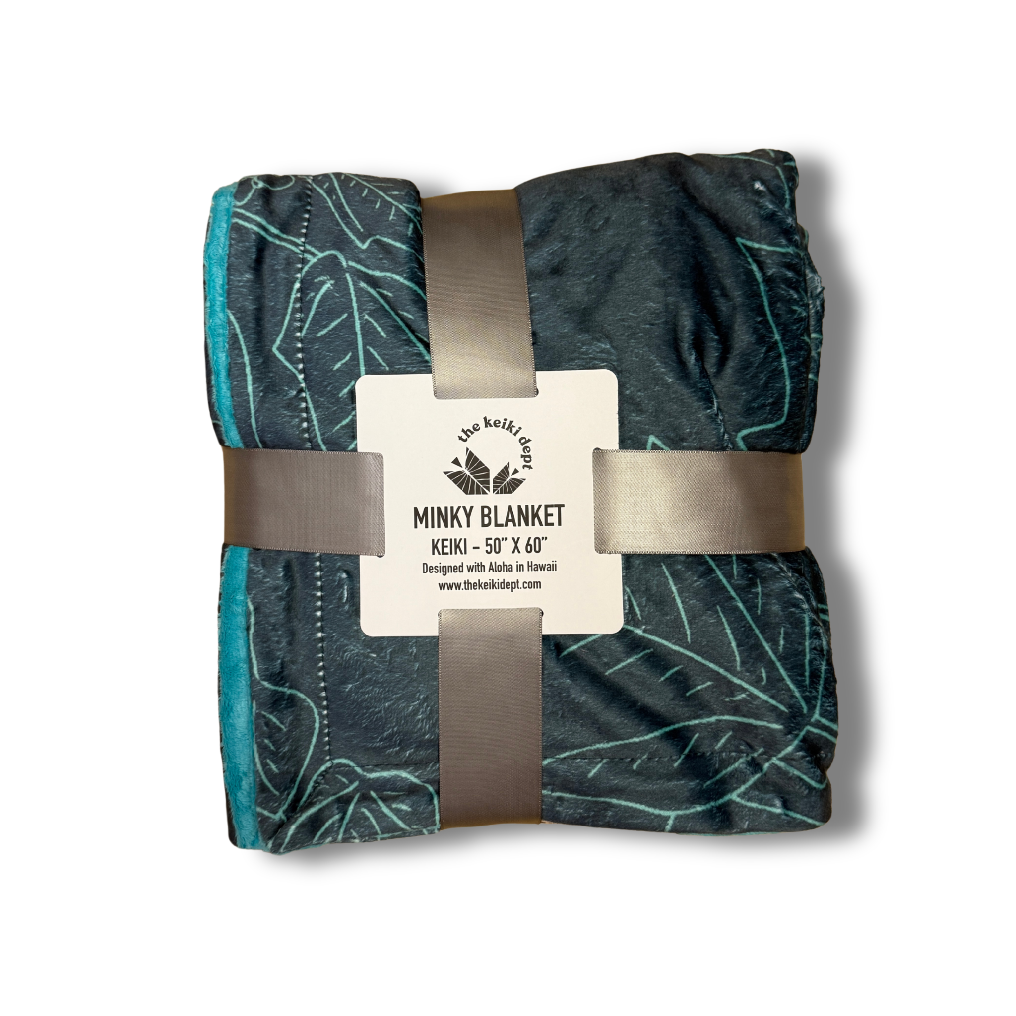 Folded blue pua kukui minky blanket with the packaging label on a white background