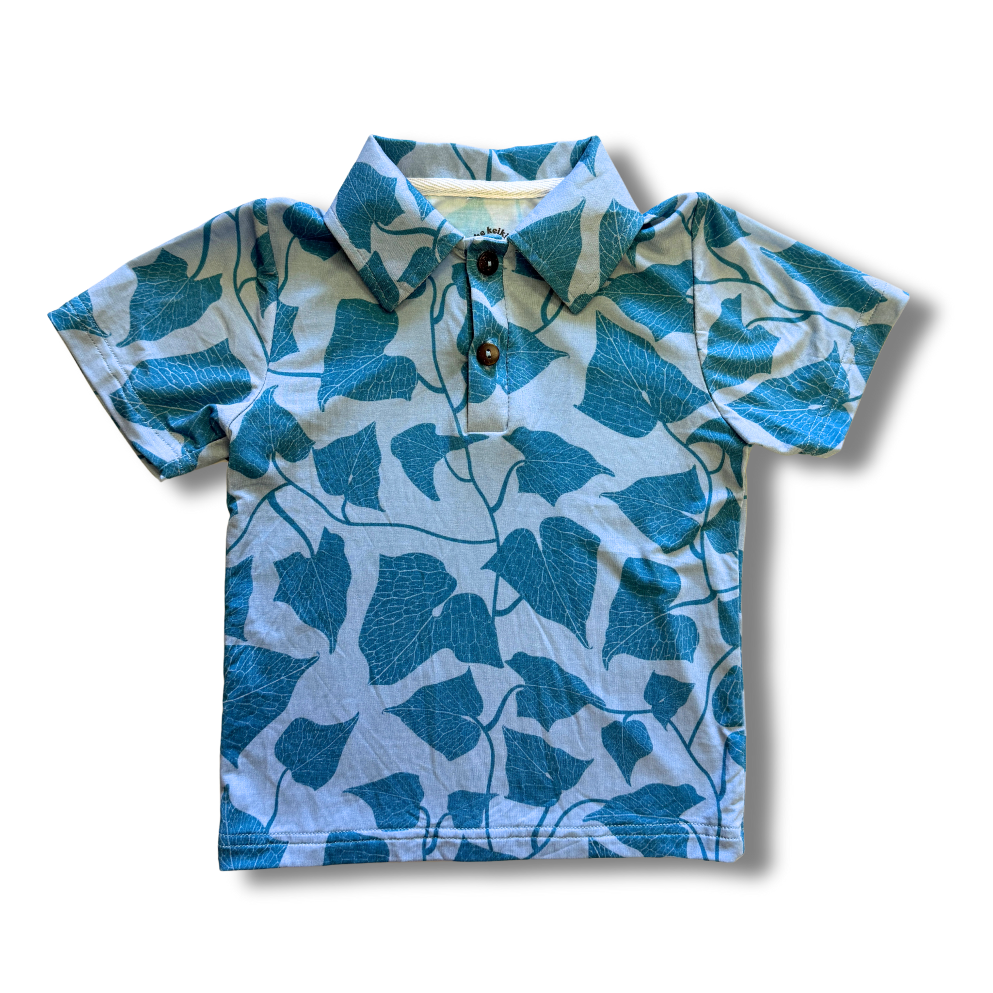 Blue leaf-patterned polo shirt on a white background